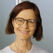 Smiling woman with short dark hair and glasses